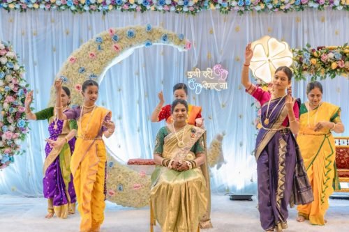 Baby shower photography pune — cake cutting moment by Nestled Photography Baner Pune
